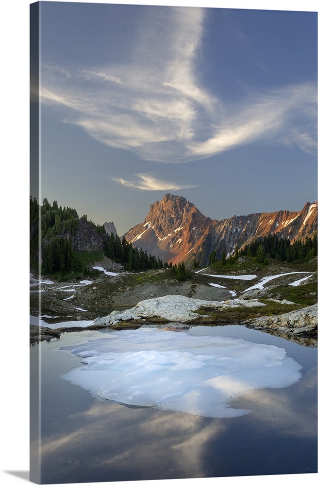 Partially thawed tarn, Yellow Aster Butte Basin. American Border Peak is in the distance. Mount Baker Wilderness, North Ca...