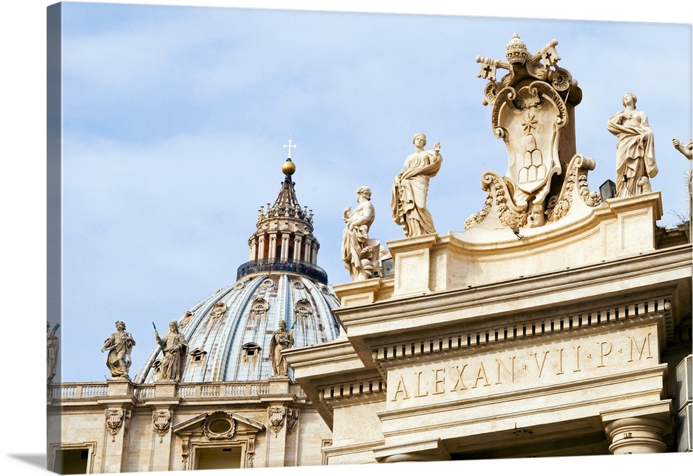 Pope's insignia between two statues of saints on the Bernini's 17th century colonnade, Piazza San Pietro, St. Peter's squa...