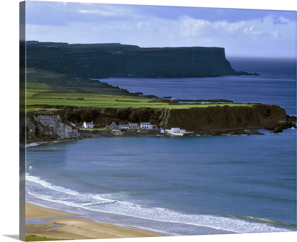 Northern Ireland, County Antrim, Port Bradden. Port Bradden, on Whitepark Bay, is dwarfed by cliffs off Antrim Coast, in N...