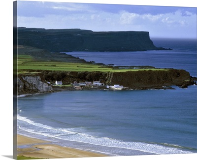 Portbradden on Whitepark Bay, is dwarfed by cliffs off Antrim Coast, in Northern Ireland