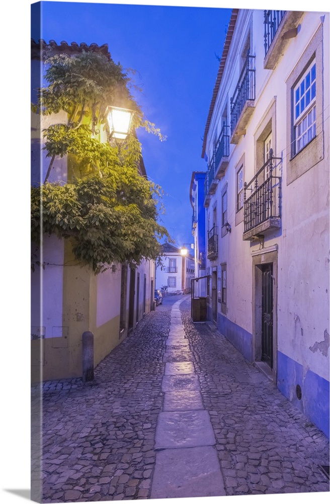 Portugal, Obidos, Cobblestone Street in the Historic Center at Dawn.