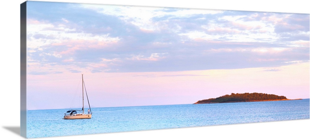 Panorama of the bay a sailing boat moored in the bay island in the background, off the Korcula island at sunset. Prizba vi...