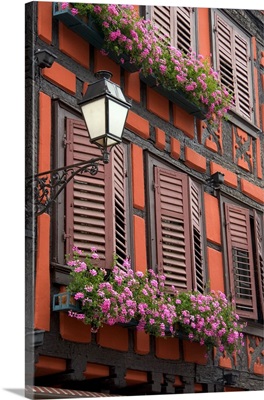 Red building with shuttered windows and flower boxes, Ribeauville, Eastern France