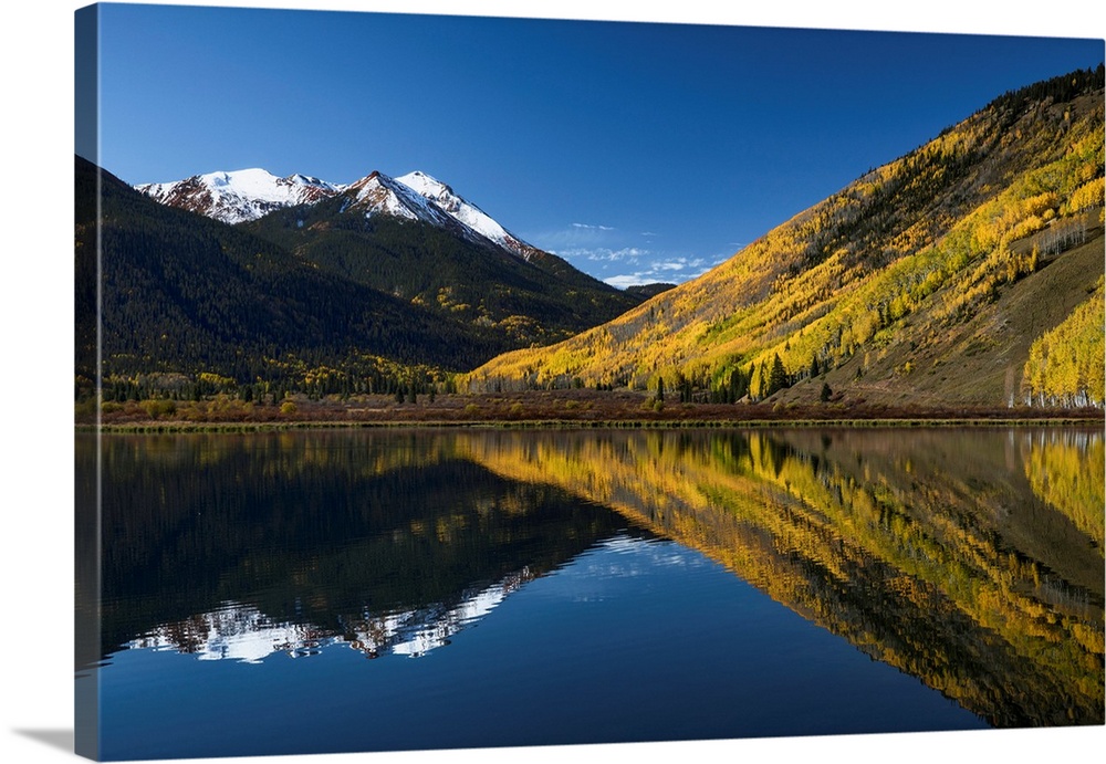 Red Mountain and autumn aspen trees reflected on Crystal Lake at sunrise, near Ouray, Colorado
