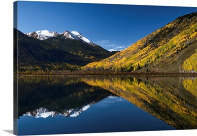 Red Mountain and aspen trees reflected on Crystal Lake at sunrise, near Ouray, Colorado