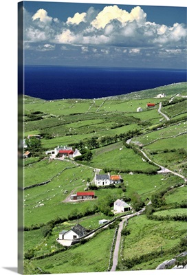 Red-roofed homes interrupt the green of Ring of Kerry, in County Kerry, Ireland