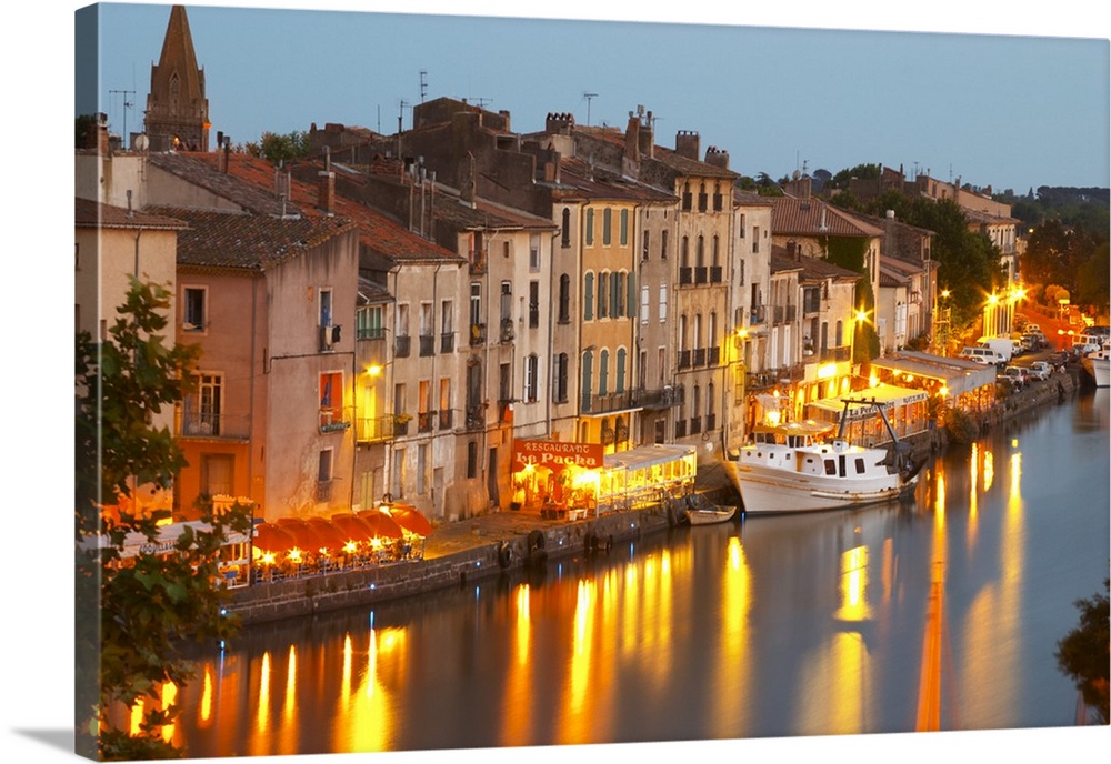 Restaurants along the l'Herault river. L'Herault river. A fishing boat. Agde town. Languedoc. France. Europe.