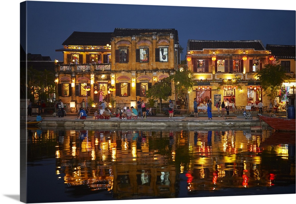 Restaurants and tourists reflected in Thu Bon River at dusk, Hoi An (UNESCO World Heritage Site), Vietnam