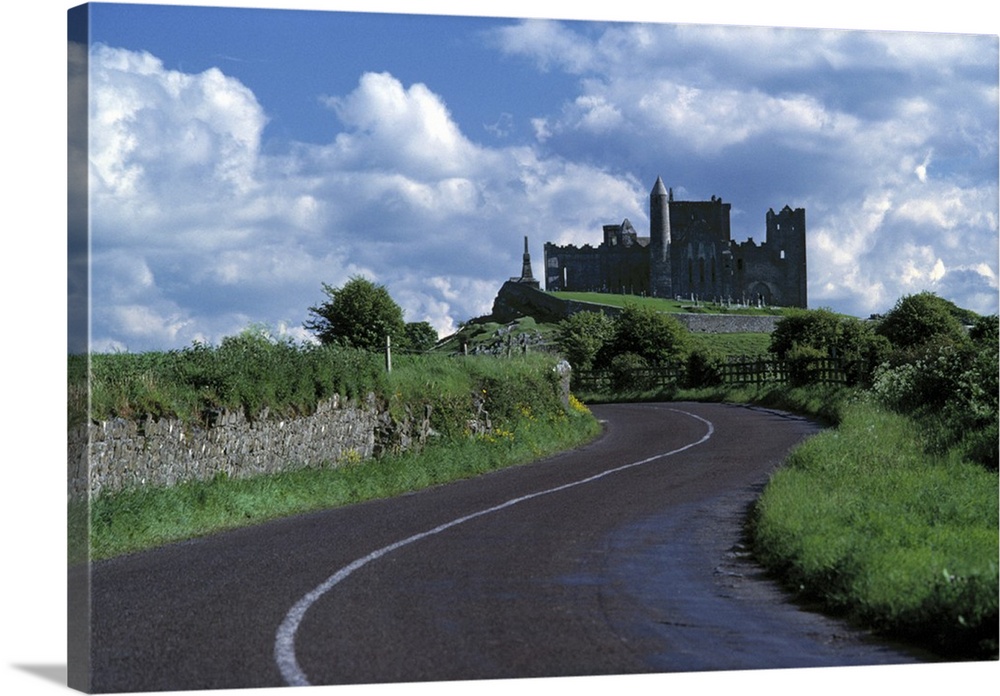Europe, Ireland, Cashel. The stately Rock of Cashel stands darkly against a sky bright with clouds in County Tipperary, Ir...