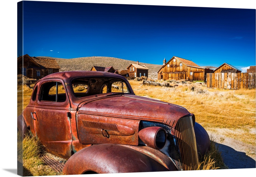Rusted car and buildings, Bodie State Historic Park, California USA.