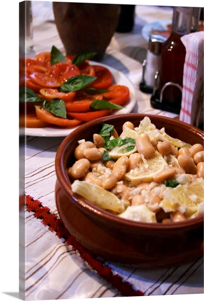 Salad with white beans in an earthenware bowl. Tomato and basil salad. White beans typical for south east Albania. Tradita...