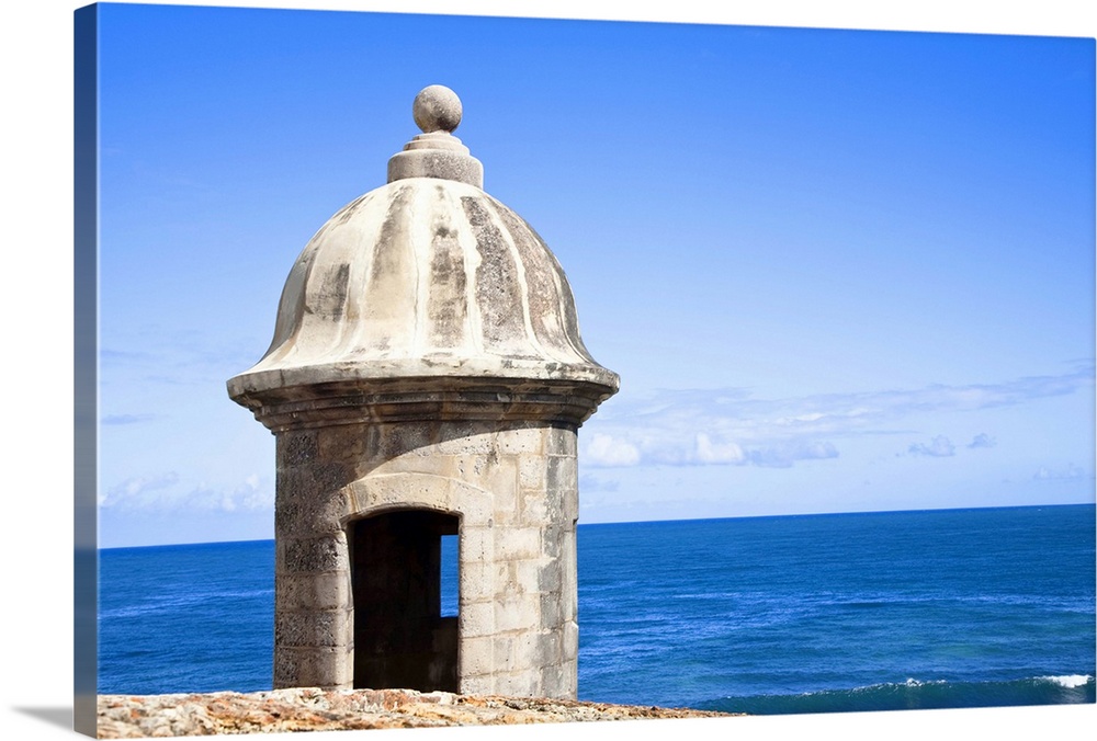 San Juan, Puerto Rico - An old stone watchtower looks out over the ocean. Horizontal shot.