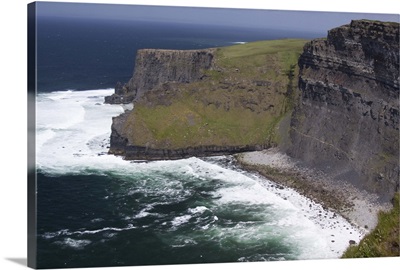 Scenic Cliffs of Moher and beach with the Atlantic Ocean and choppy waves