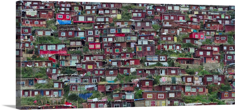 Red log cabins lived by nuns and monks covering the mountain side, Seda Larung Wuming, the world's largest Tibetan Buddhis...