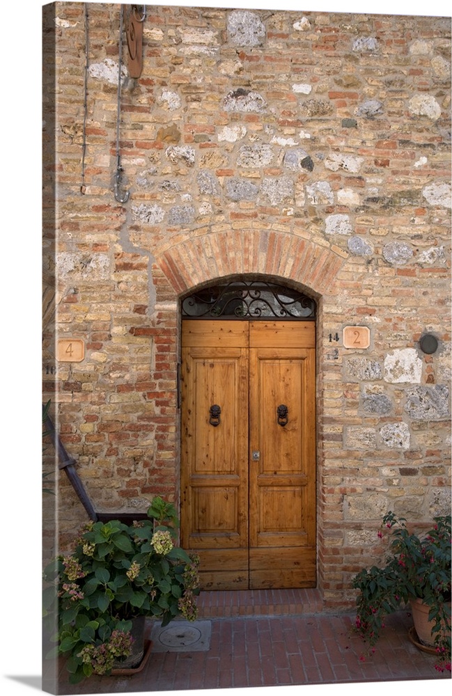 Sienna, Tuscany, Italy - Wooden doors in a brick and stone building. Vertical shot.