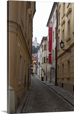 Slovakia, Bratislava. Narrow street with view of Bratislava Castle in distance