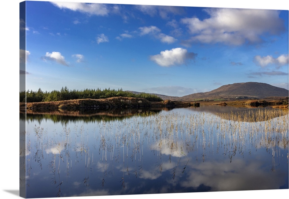Small lake reflecting clouds near Clifden, Ireland