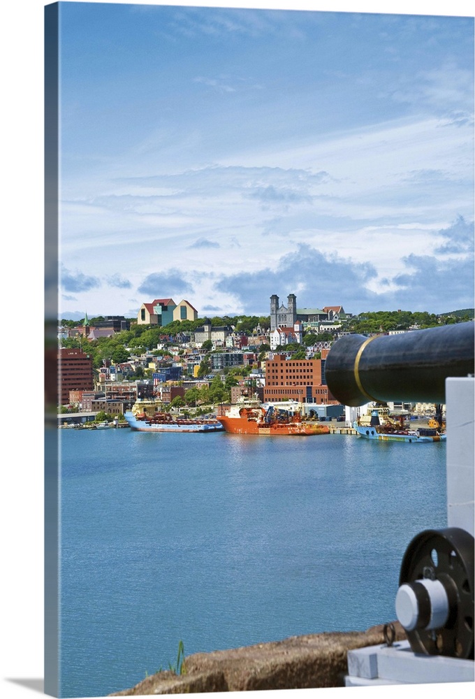 St. John's, Newfoundland, Canada, the waterfront of St. John's as seen from near a cannon at Fort Cabot on Signal Hill acr...