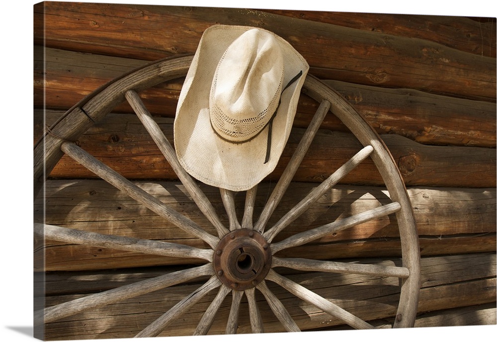 North America, USA, California, Yosemite National Park. Straw hat and a wagon wheel left from the mule train in Yosemite.