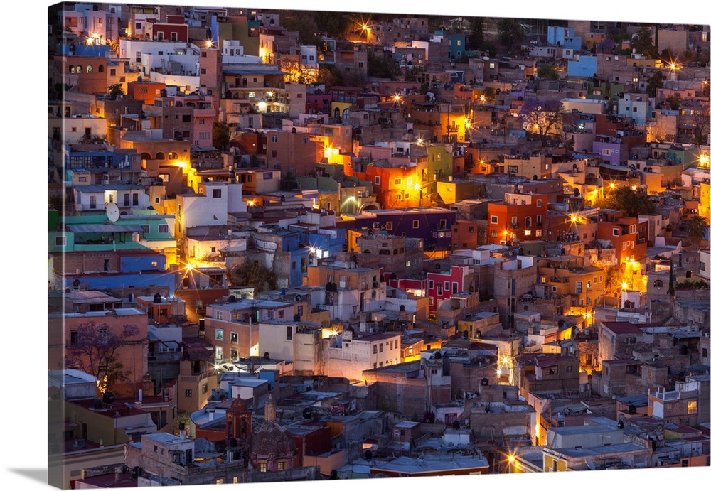 Mexico, Guanajuato. Street lights add ambience to this twilight village scene.