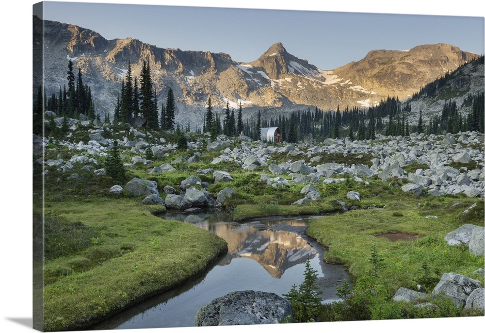 Mountains reflected in creek, subalpine meadows of Marriott Basin, Coast Mountains, British Columbia