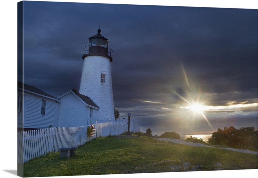 Sun breaks through the clouds at Pemaquid Point Lighthouse in New Harbor, Maine, USA