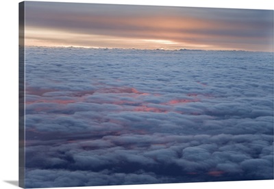 Sunrise From An Airliner Looking Down At Clouds