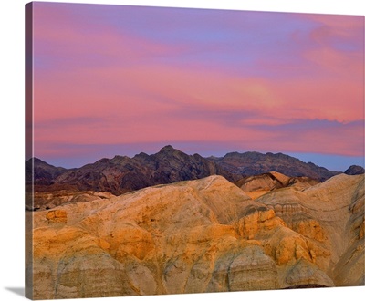 Sunset colors the sky with vibrant pink and purple in Death Valley, California