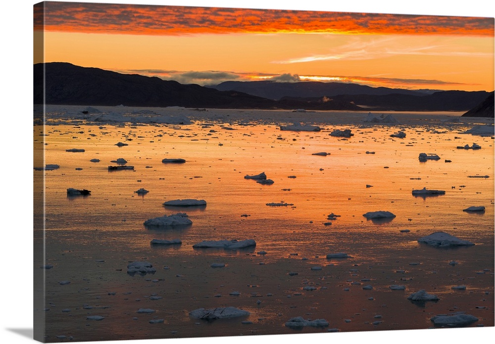 Sunset over fjord with icebergs close to Eqip Sermia glacier in Denmark's overseas territory, Greenland.