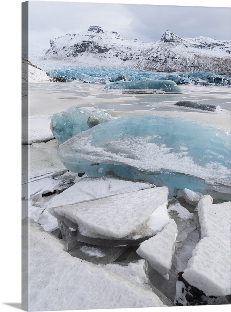 Svinafellsjoekull Glacier in Vatnajokull during winter. Glacier front and the frozen glacial lake..