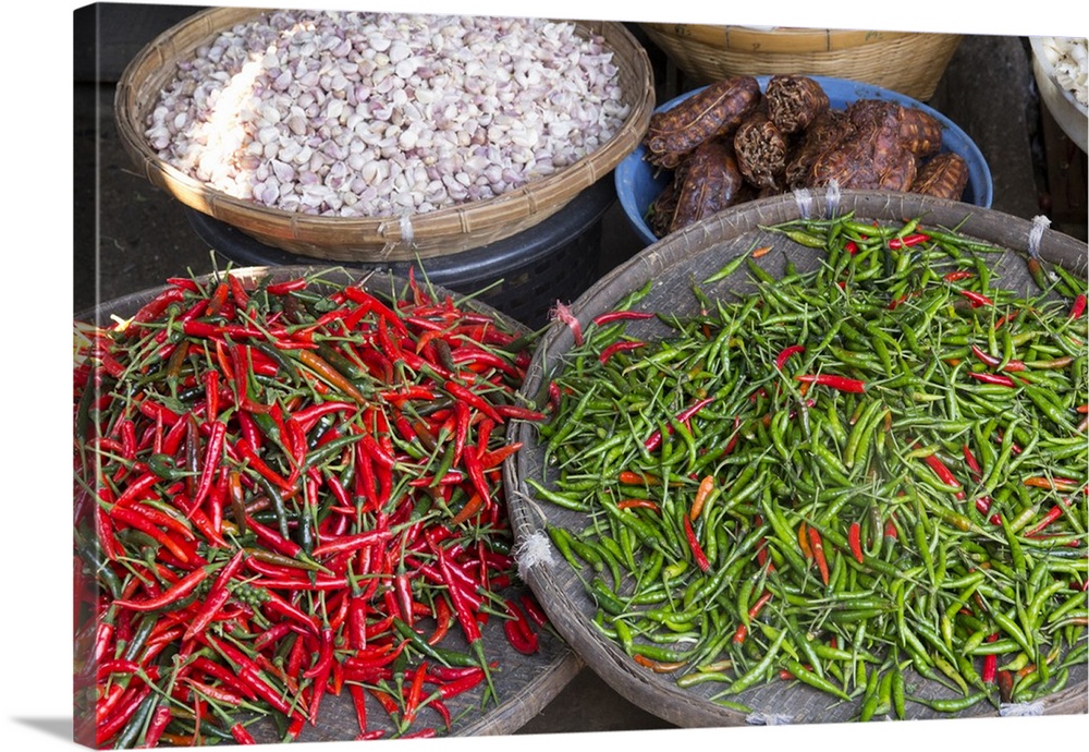 Thailand, Chiang Mai. Thai street vendor of green and red Chilies.