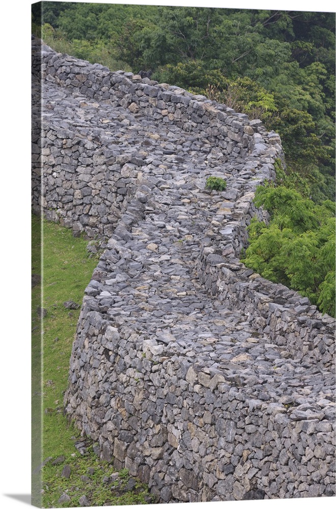 The tall stone walls are all that remain of Nakijin Castle, a 14th Century castle in Okinawa, Japan.