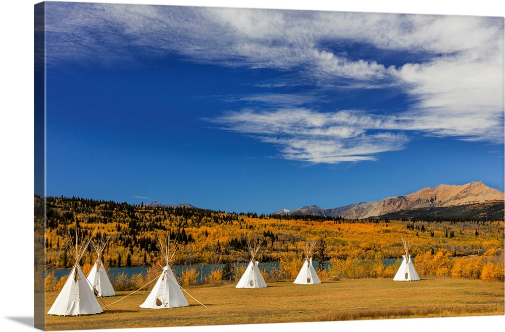 Tipis with Yellow Mountain in background at Chewing Black Bones campground near St Mary, Montana, USA