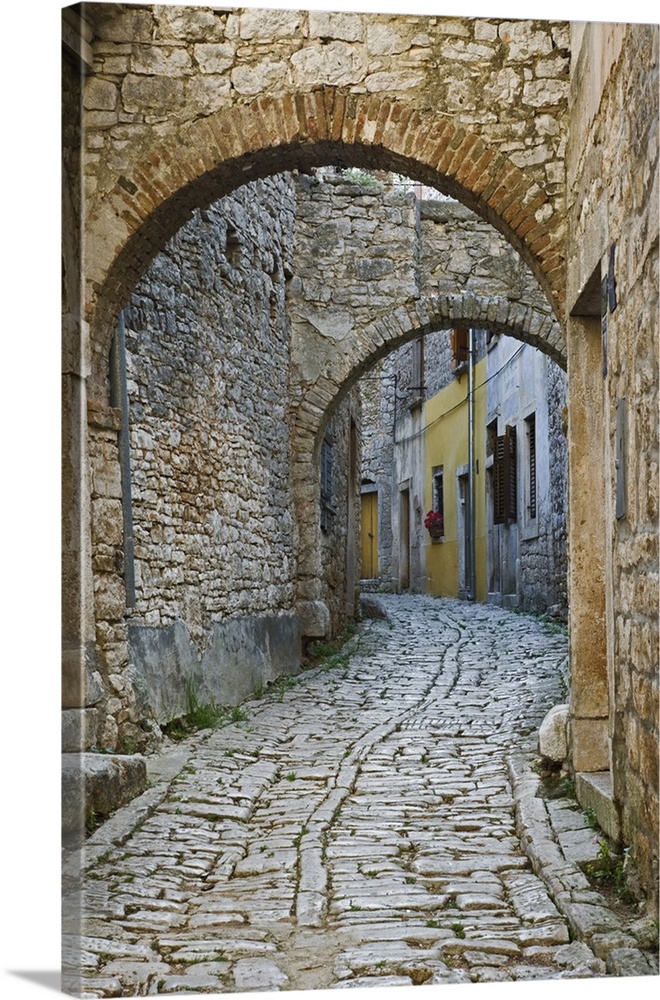 Twin arches above cobblestone stree, Bale, Croatia
