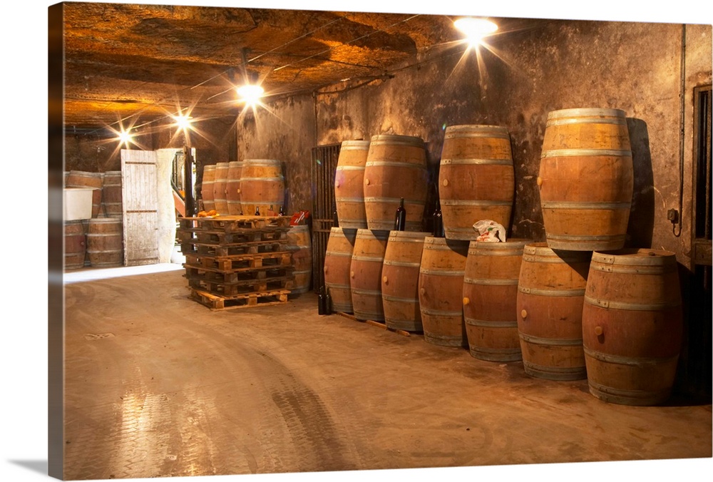 The underground winery and cellar in an old stone quarry, empty oak barrels waiting to be filled with wine  Chateau Belair...
