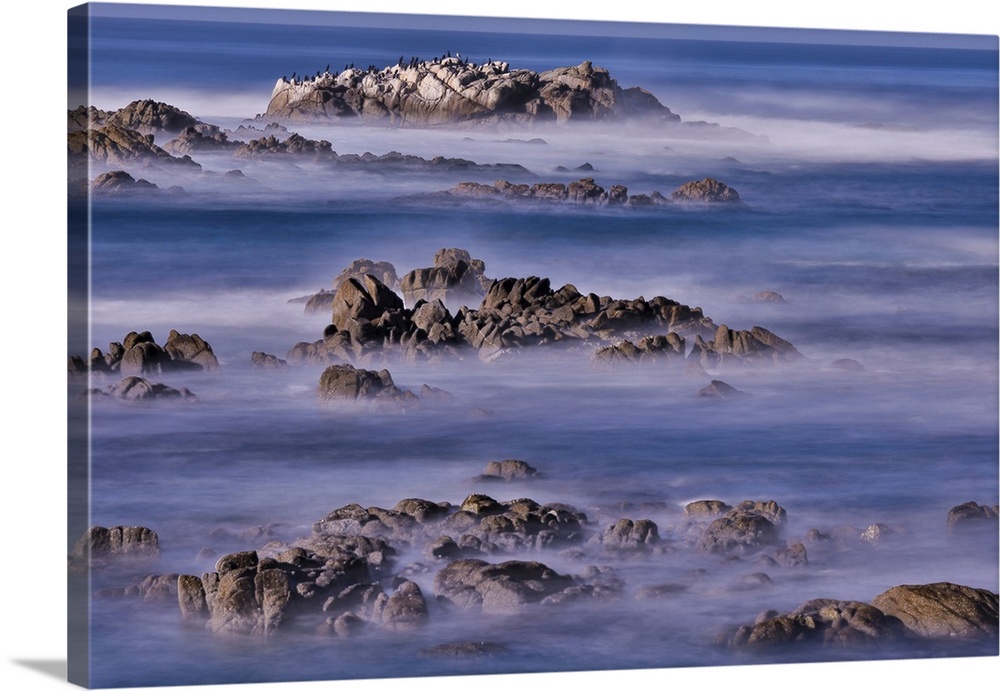 USA, California, Pacific Grove. Monterey Bay, surf crashing in on rocks.