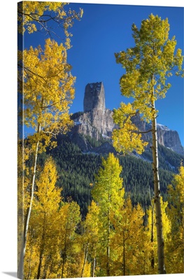 USA, Colorado, San Juan Mountains, Aspen trees frame Chimney Rock formation