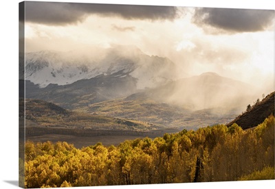 USA, Colorado, San Juan Mountains, Snow Flurries Over Mountain And Valley At Sunset