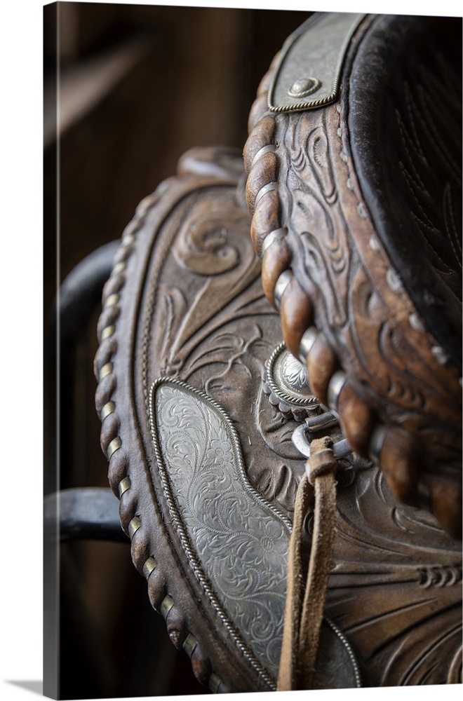 USA, Colorado, Custer County, Westcliffe, Music Meadows Ranch. Tack room. Tooled leather western saddle. United States, Co...