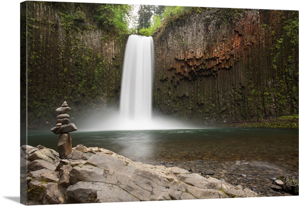 USA, Oregon. Abiqua Falls and stacked pile of rocks.