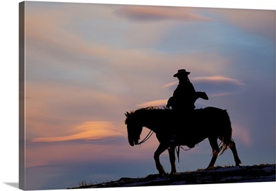 USA, Shell, Wyoming, Hideout Ranch Cowgirl Silhouetted On Horseback At Sunset