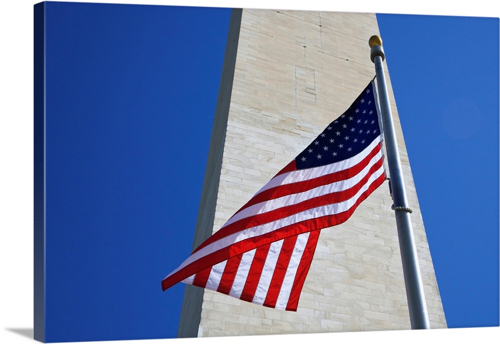 USA, Washington DC. American flag and the Washington Monument.