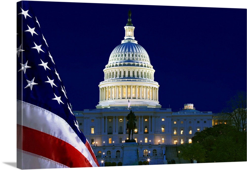 USA, Washington, DC. Capitol Building and US flag at night.