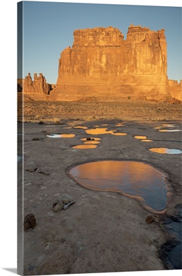 Utah, Arches National Park. Reflected light from the Organ in icy pot holes