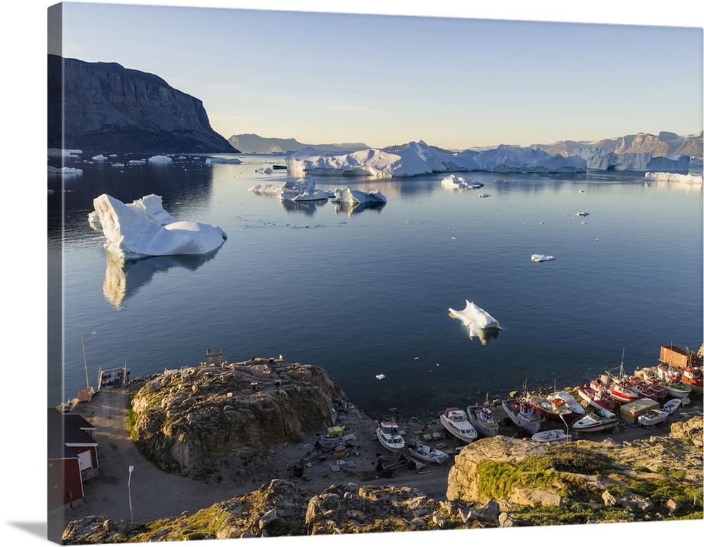 View of fjord full of icebergs towards Nuussuaq peninsula during midnight sun.