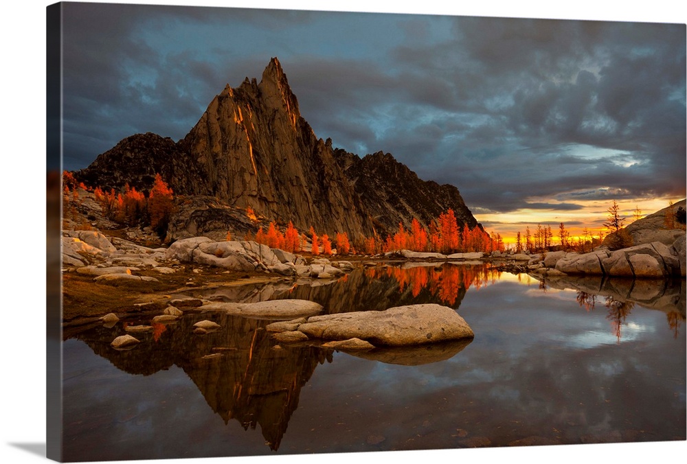 Washington, Alpine Lakes Wilderness Enchantments. Prusik Peak is reflected in Gnome Tarn at sunrise, with glowing, backlit...