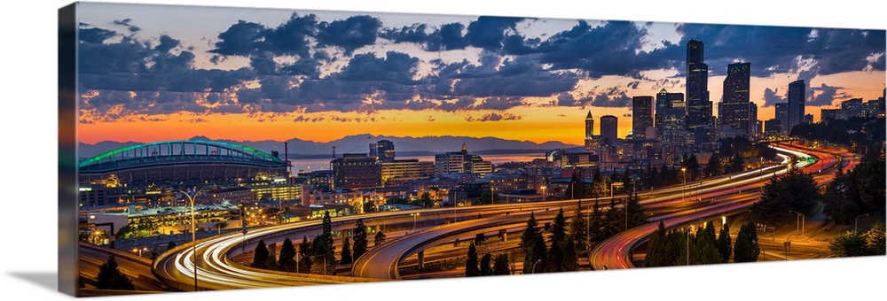 USA, Washington State, Seattle. Sweeping sunset view from Century Link Field to downtown over twisting I-5, from the Jose ...