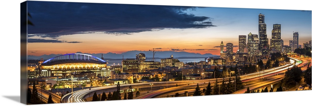 USA, Washington State, Seattle. Sweeping sunset view from Century Link Field to downtown over twisting I-5, from the Jose ...