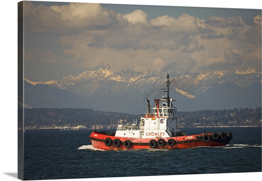 Washington, Seattle, Tug boat on Elliott Bay with Olympic mountains.