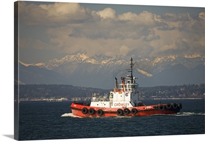 Washington, Seattle, Tug boat on Elliott Bay with Olympic mountains
